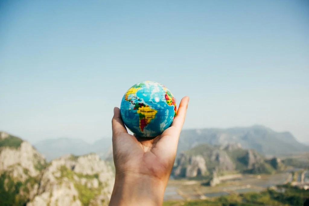 An image of a globe held by a human hand